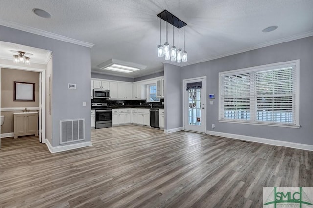 kitchen with visible vents, open floor plan, light wood-type flooring, appliances with stainless steel finishes, and white cabinets