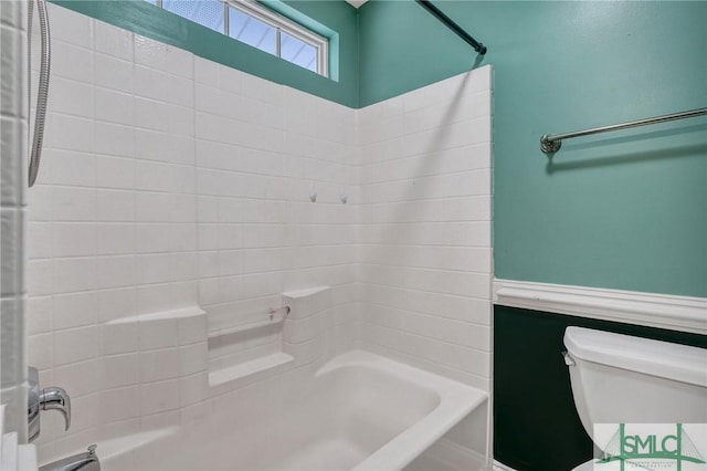 full bath with wainscoting, toilet, and shower / bath combination