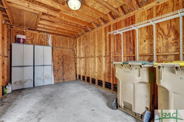 interior space featuring a garage and concrete flooring