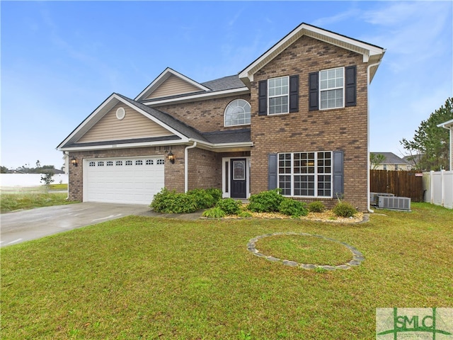 traditional-style home featuring brick siding, an attached garage, a front lawn, fence, and driveway