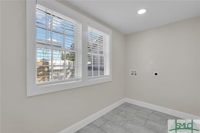 washroom with baseboards, light tile patterned floors, laundry area, hookup for a washing machine, and electric dryer hookup