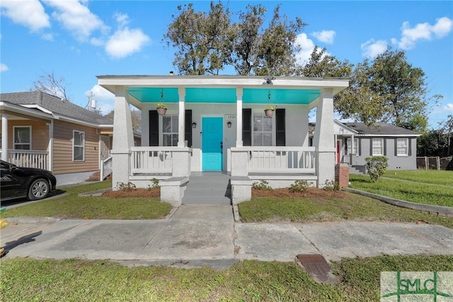 bungalow-style home with a porch and a front lawn