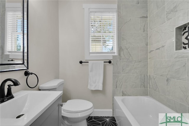 full bathroom featuring toilet, tile patterned flooring, baseboards, a bath, and vanity