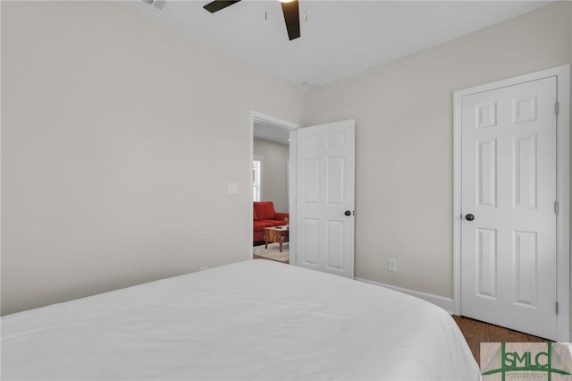 bedroom with a ceiling fan and wood finished floors