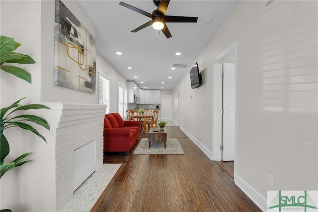 corridor with visible vents, recessed lighting, dark wood-style floors, and baseboards