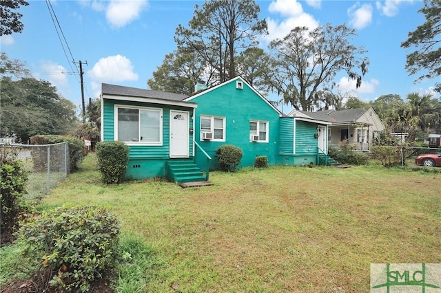 bungalow-style home with crawl space, entry steps, a front yard, and fence