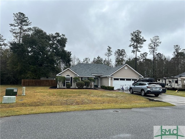 ranch-style house with a front lawn, an attached garage, driveway, and fence