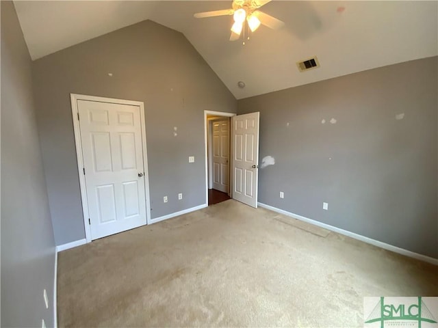 unfurnished bedroom with vaulted ceiling, baseboards, visible vents, and light carpet