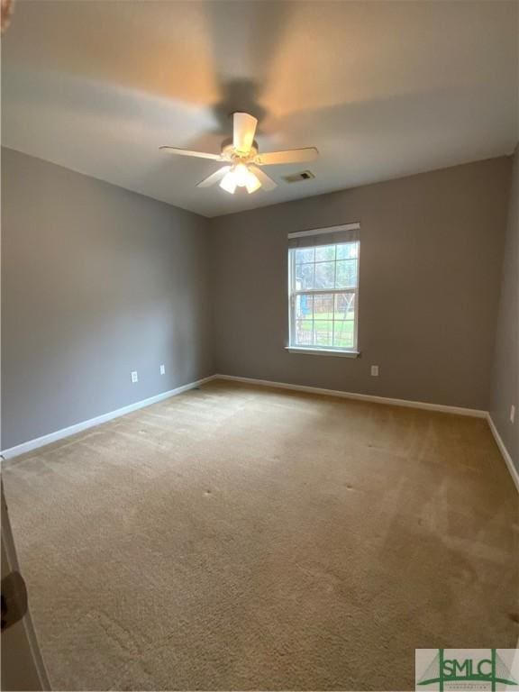 carpeted empty room featuring a ceiling fan, baseboards, and visible vents