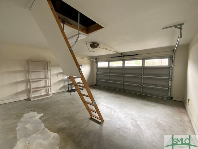 garage with a garage door opener and baseboards