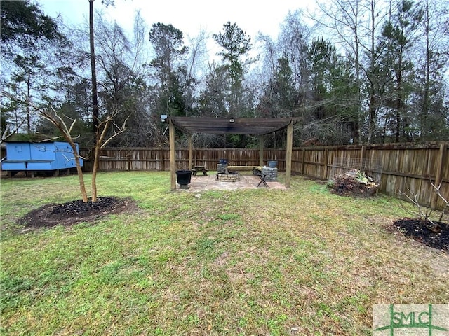 view of yard featuring a patio, a fenced backyard, a pergola, and an outdoor fire pit