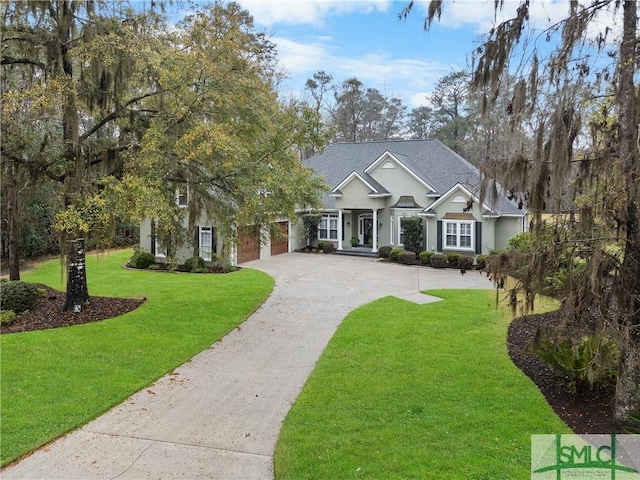 view of front of property featuring a front yard, a garage, and driveway