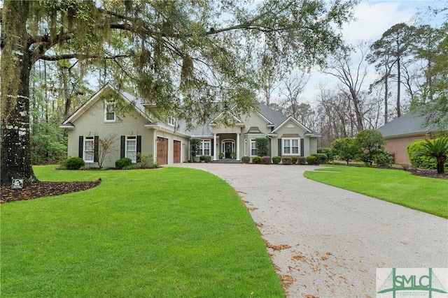 view of front of property featuring aphalt driveway, a front lawn, an attached garage, and stucco siding