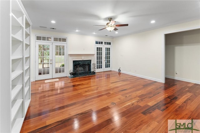 unfurnished living room featuring recessed lighting, french doors, and hardwood / wood-style flooring