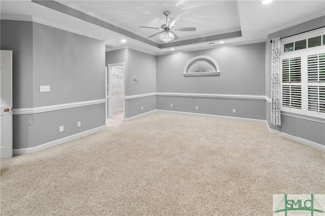 empty room featuring recessed lighting, a tray ceiling, baseboards, and ceiling fan