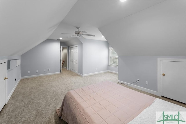 unfurnished bedroom featuring a ceiling fan, baseboards, recessed lighting, vaulted ceiling, and light carpet