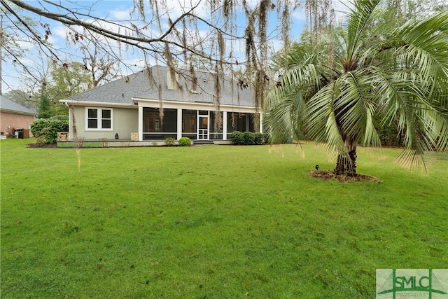 rear view of property with stucco siding, a lawn, central AC, and a sunroom