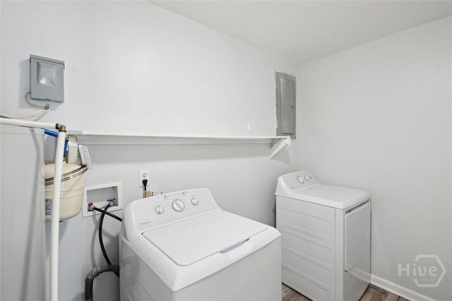 7014 Key St, Savannah, GA 31406 - laundry area featuring washer and dryer, wood finished floors, and electric panel