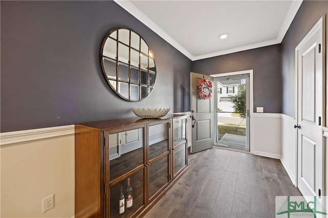 entrance foyer with wood finished floors, baseboards, and ornamental molding