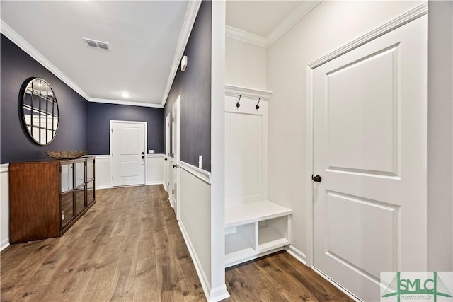 mudroom with visible vents, ornamental molding, and wood finished floors