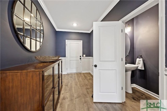 doorway to outside with baseboards, wood finished floors, and crown molding