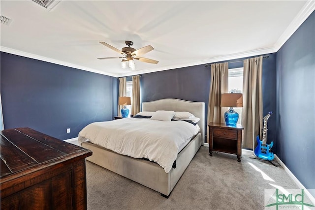 bedroom featuring a ceiling fan, baseboards, visible vents, crown molding, and carpet flooring