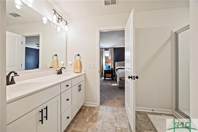 ensuite bathroom featuring a sink, visible vents, connected bathroom, and double vanity