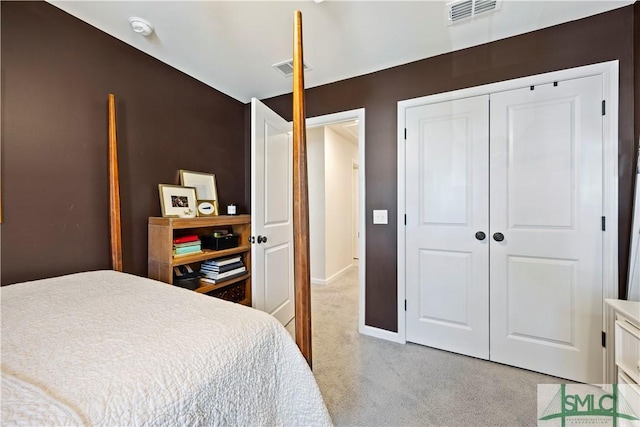 bedroom with visible vents, baseboards, light colored carpet, and a closet