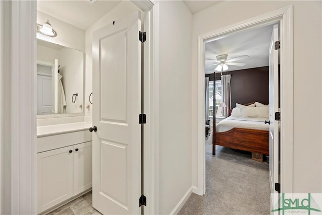 bathroom featuring vanity, a ceiling fan, and baseboards