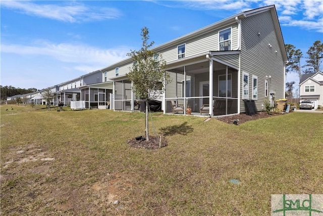 back of property featuring a yard and a sunroom