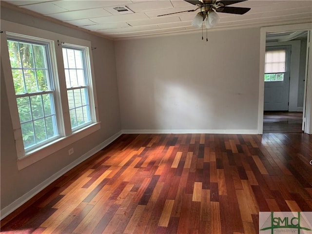 empty room with visible vents, baseboards, ceiling fan, and hardwood / wood-style flooring