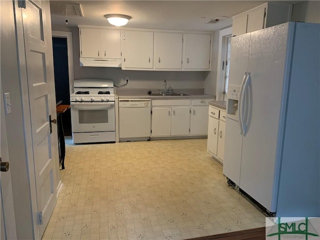 kitchen with under cabinet range hood, white appliances, light floors, and white cabinetry