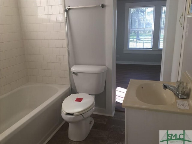 full bath featuring vanity, toilet, and baseboards