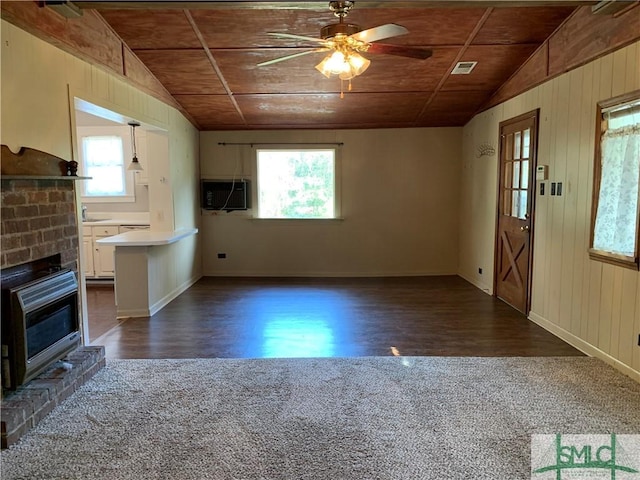 unfurnished living room with visible vents, wood ceiling, and lofted ceiling