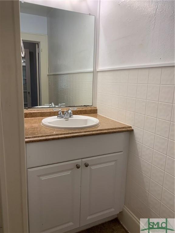 bathroom featuring tile walls and vanity