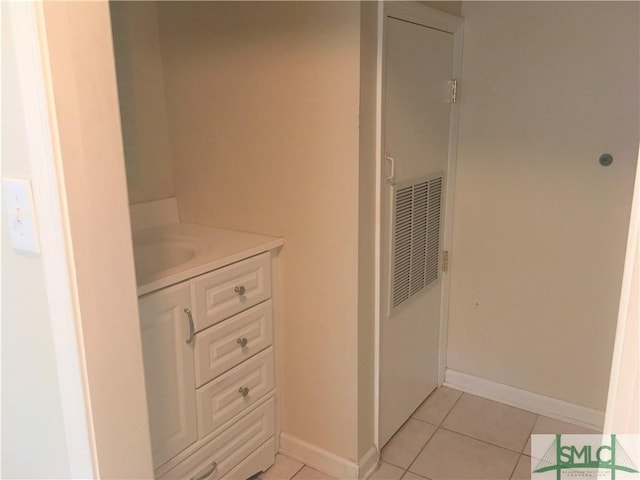 bathroom with tile patterned floors, visible vents, baseboards, and vanity