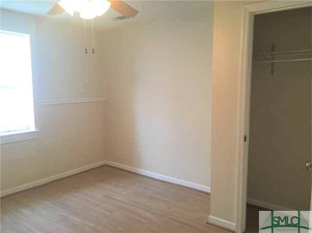 unfurnished bedroom with ceiling fan, a closet, baseboards, and wood finished floors