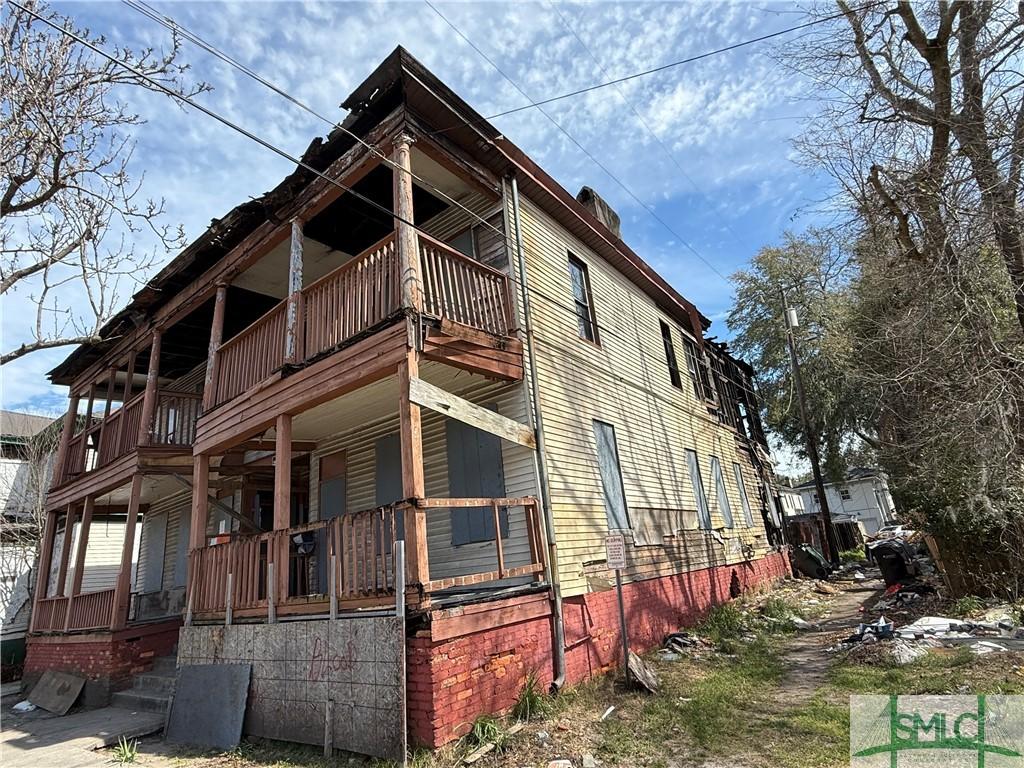 view of home's exterior featuring a balcony and covered porch