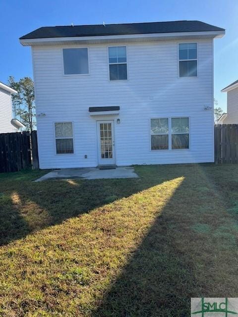 back of property featuring a patio, a lawn, and fence