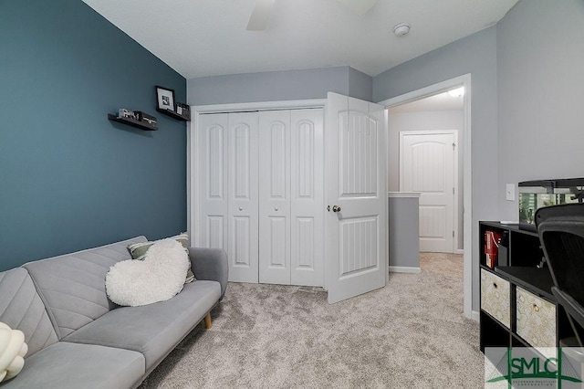 living area with light colored carpet, baseboards, and ceiling fan