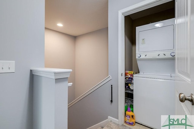 laundry area featuring laundry area, recessed lighting, and stacked washer and dryer