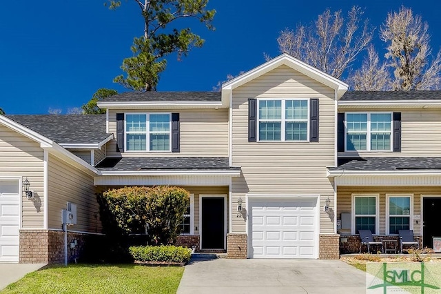 view of front of home featuring a garage, brick siding, driveway, and a shingled roof