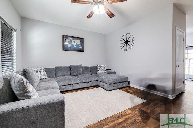 living room with baseboards, ceiling fan, and wood finished floors