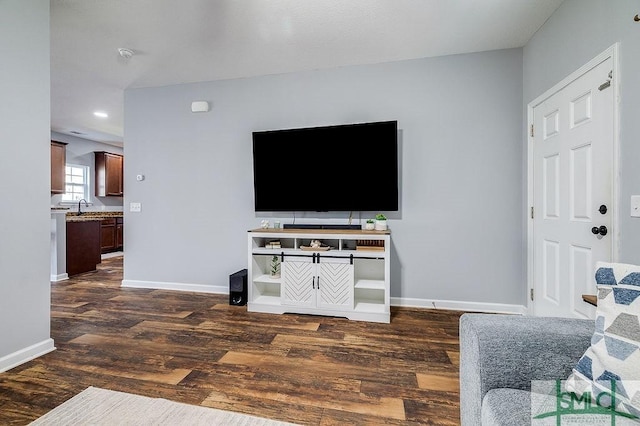 living room with baseboards and dark wood-style flooring