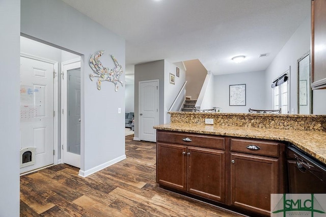 kitchen with visible vents, baseboards, dark brown cabinets, dark wood-style flooring, and light stone countertops