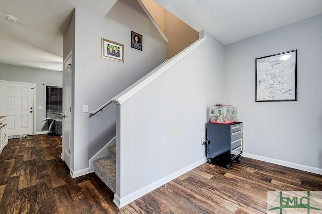 stairway with baseboards and wood finished floors