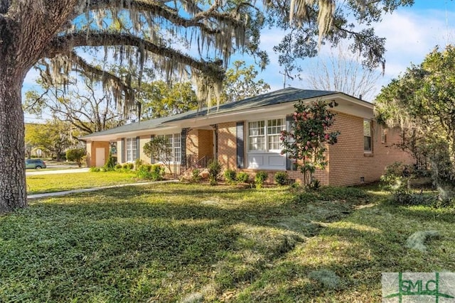 single story home with brick siding and a front yard