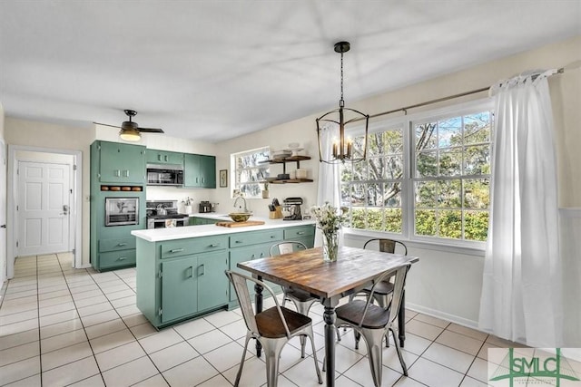 kitchen featuring open shelves, stainless steel appliances, green cabinets, light tile patterned flooring, and light countertops