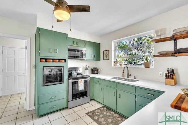 kitchen with open shelves, stainless steel appliances, light countertops, and a sink