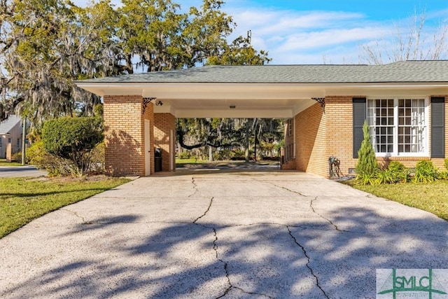 exterior space featuring an attached carport and driveway